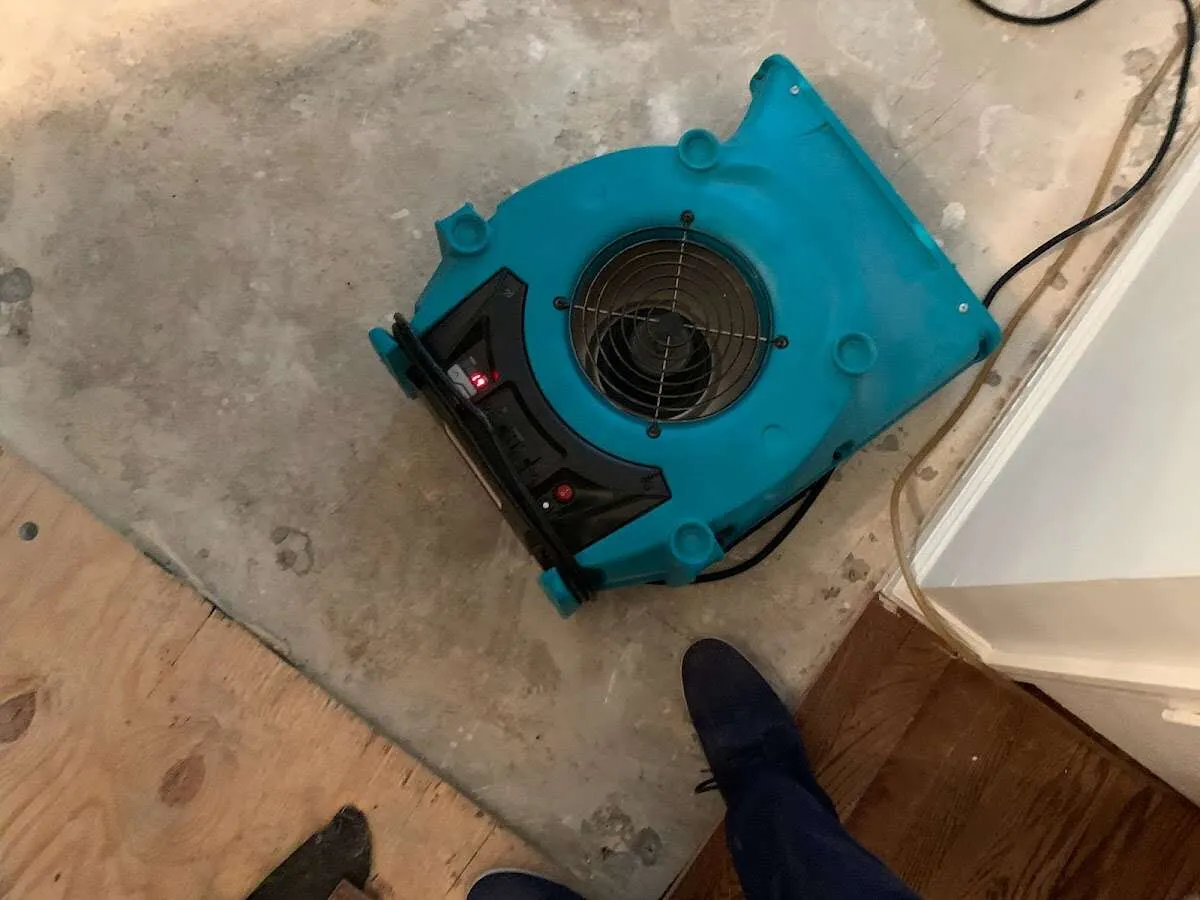 Air mover drying subfloor during Commercial Water Damage Restoration in Crest Hill